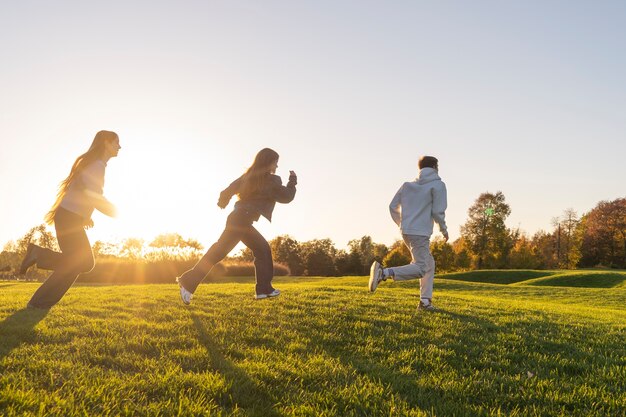 Full shot friends jumping outdoors