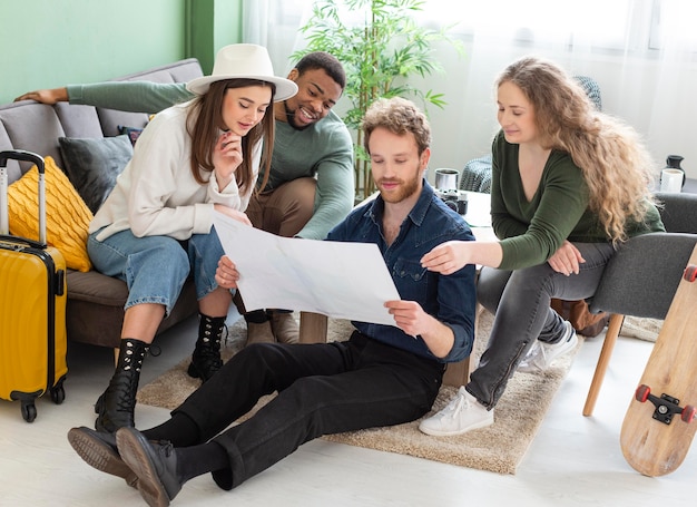 Full shot friends looking at map