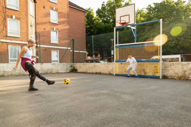 Free photo full shot friends playing with ball