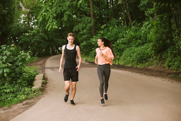 Full shot friends running outdoors