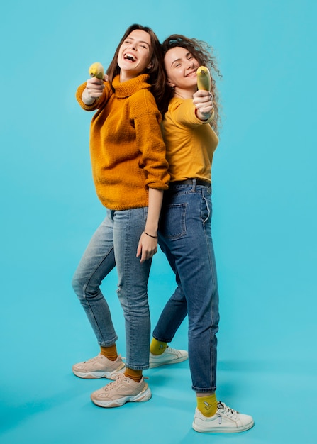 Free Photo full shot of friends staying back to back
