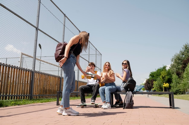 Free photo full shot friends with penny boards