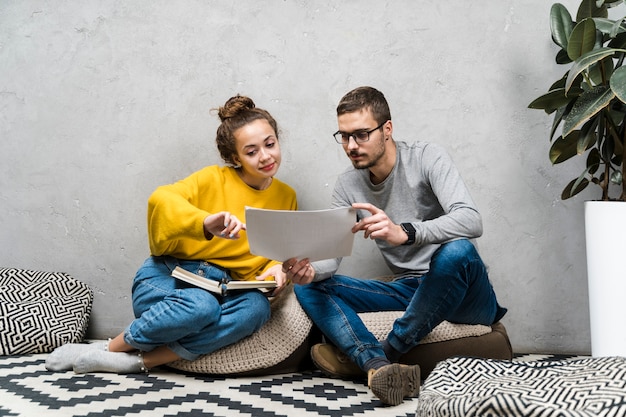 Full shot girl and boy reading something