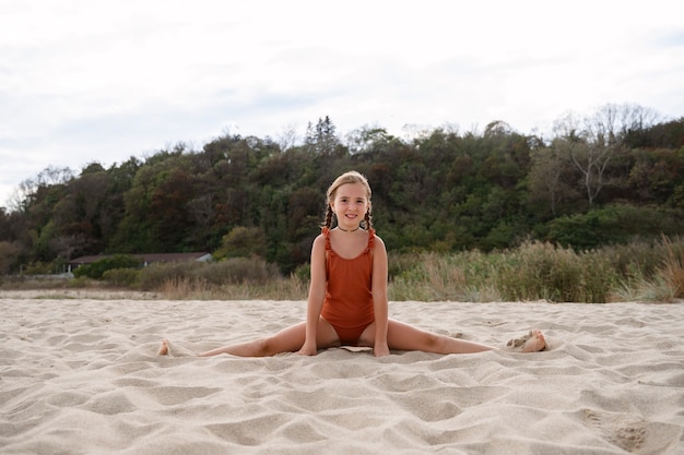 Free photo full shot girl having fun at the beach