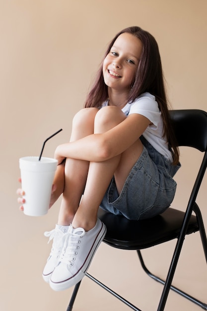 Full shot girl holding cup