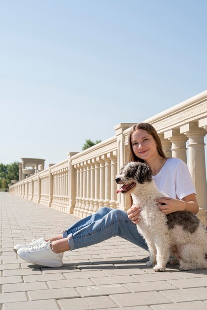 Full shot girl holding cute dog