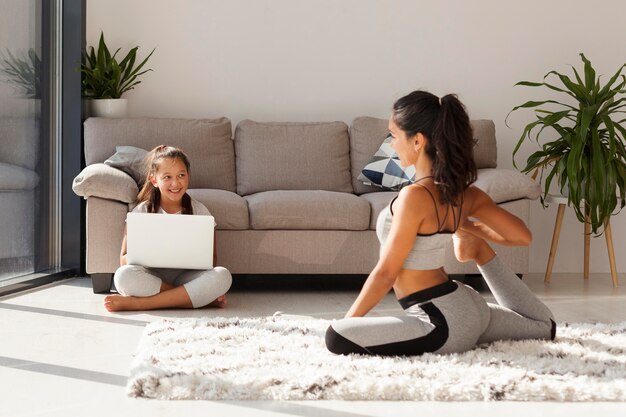 Full shot girl holding laptop