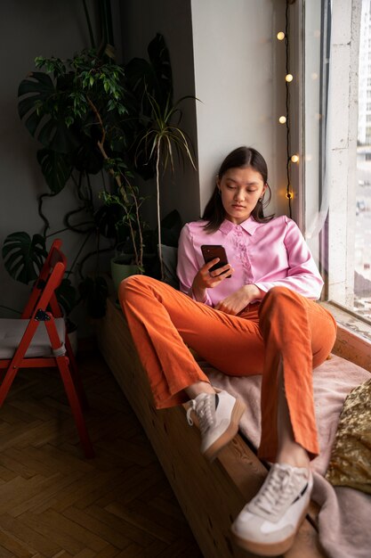 Full shot girl laying indoors