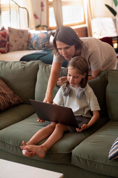 Full shot girl learning to work on laptop