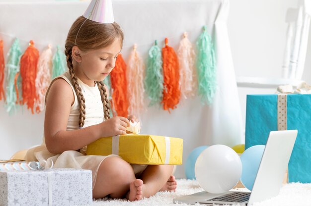 Full shot girl opening present