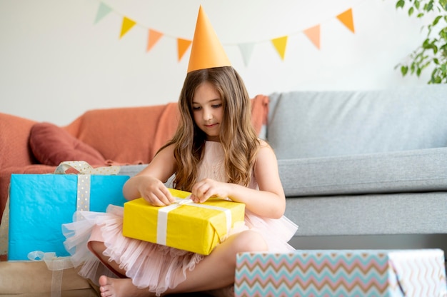 Free photo full shot girl opening present