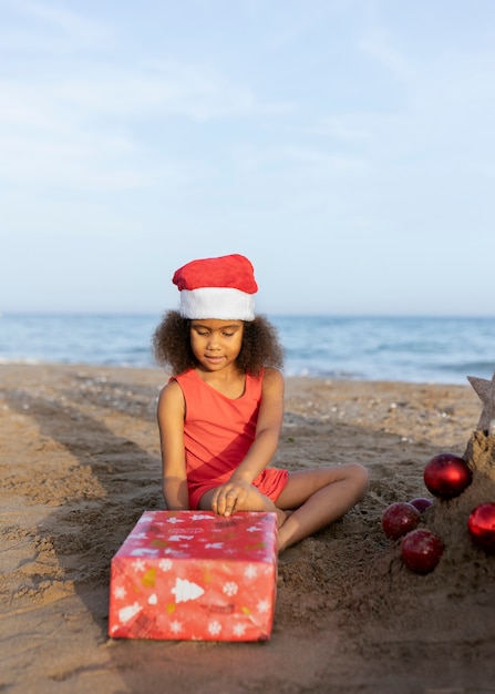 Full shot girl opening present