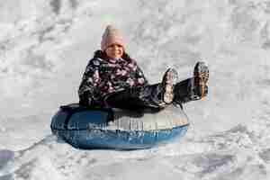 Free photo full shot girl playing in snow