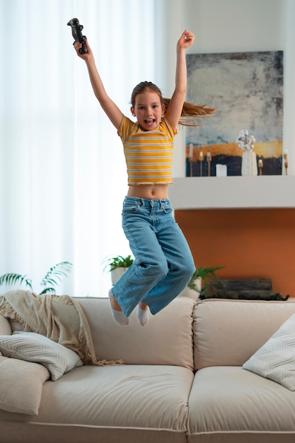 Free photo full shot girl playing videogames