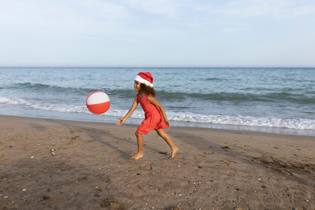 Full shot girl playing with ball