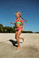 Free photo full shot girl running on beach
