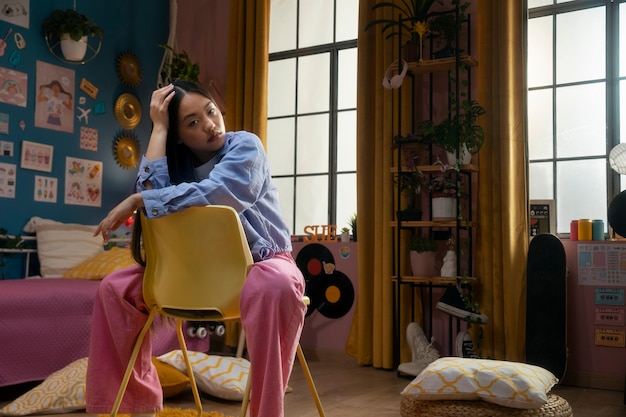 Full shot girl sitting on chair