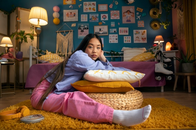 Full shot girl sitting on floor