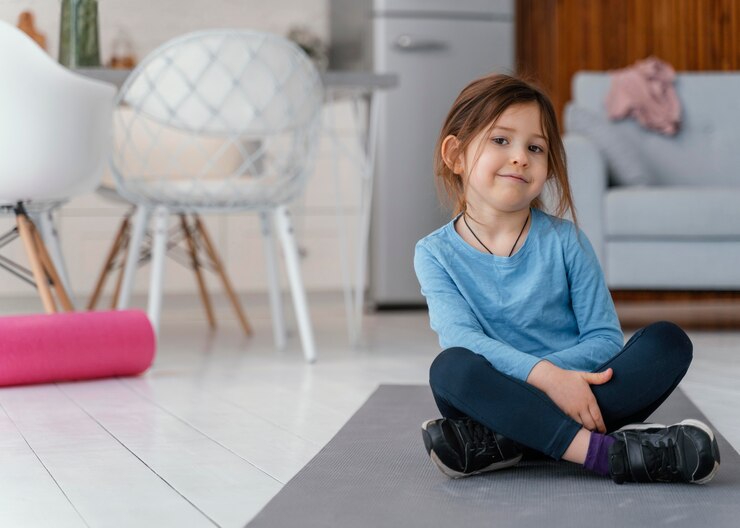Free Photo full shot girl sitting  on mat