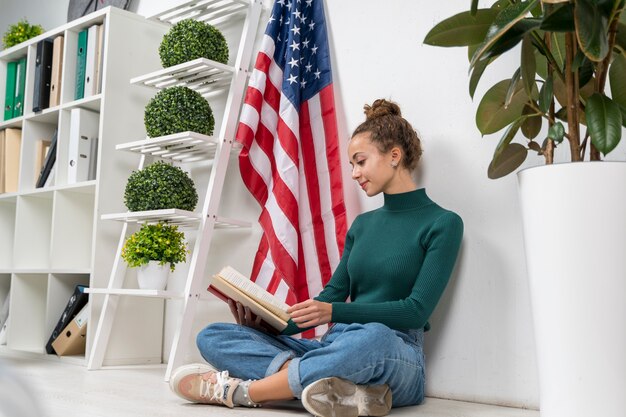 Full shot girl sitting and reading