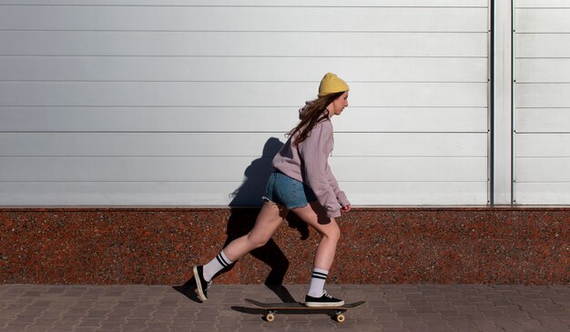 Full shot girl skating outside