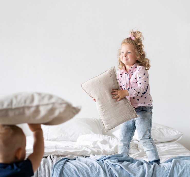 Free Photo full shot girl standing in bedroom with pillow 