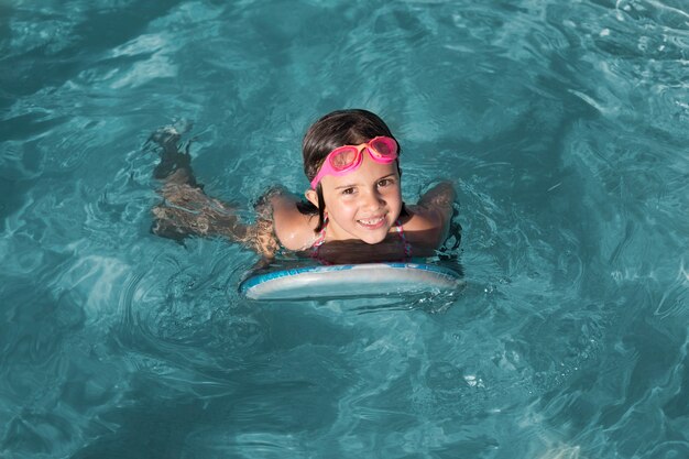 Full shot girl swimming with goggles