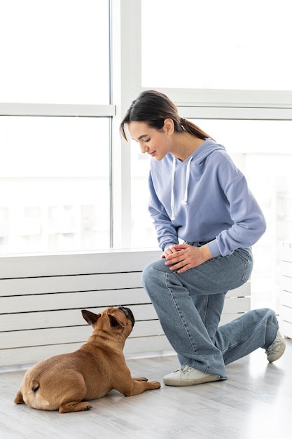 Full shot girl talking to dog