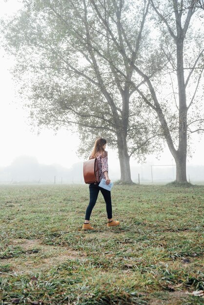 Full shot girl walking through nature