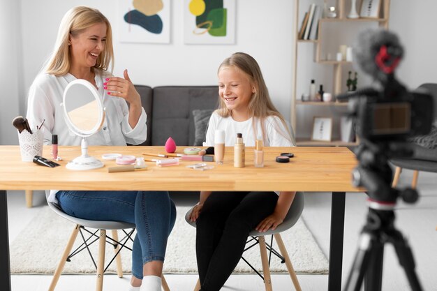 Full shot girl and woman sitting