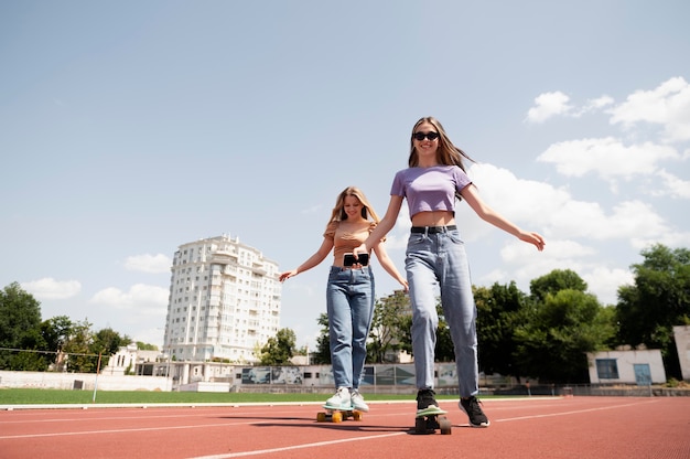 Full shot girls on penny boards