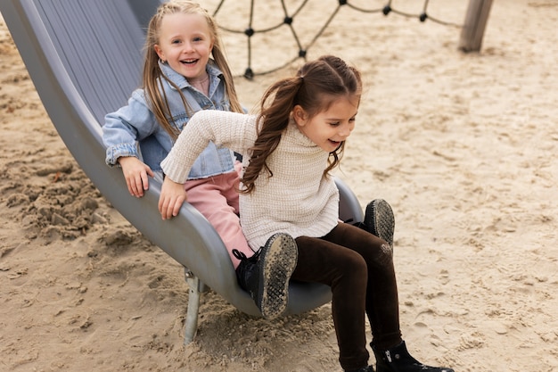 Full shot girls on slide