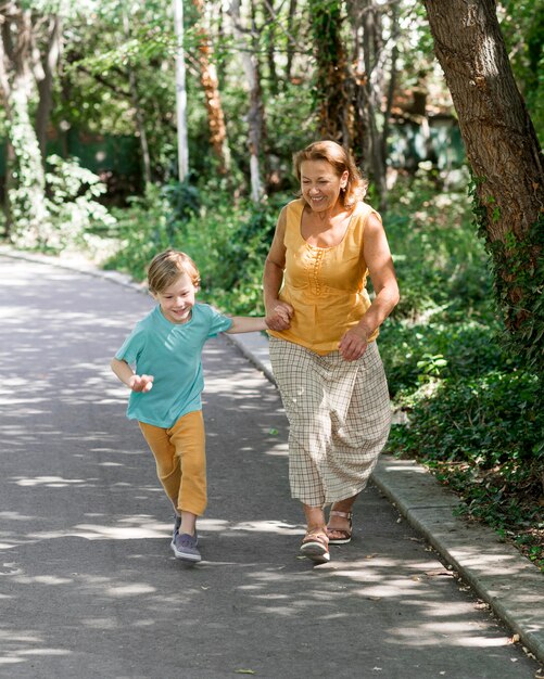 Full shot grandma and kid running