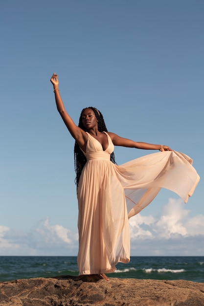 Full shot greek goddess posing at beach