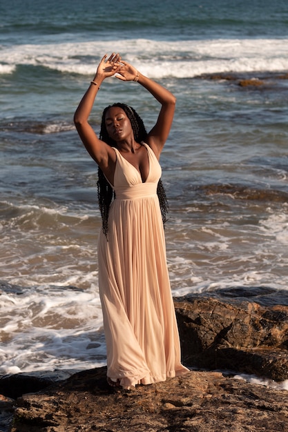 Free photo full shot greek goddess posing at beach