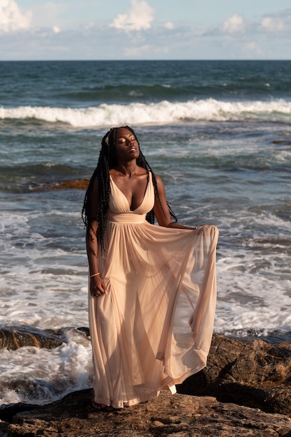 Free photo full shot greek goddess posing at beach