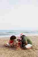 Free photo full shot happy family at beach