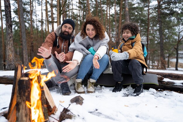 Full shot happy family by the fire