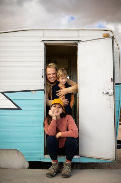 Full shot happy family in camper van