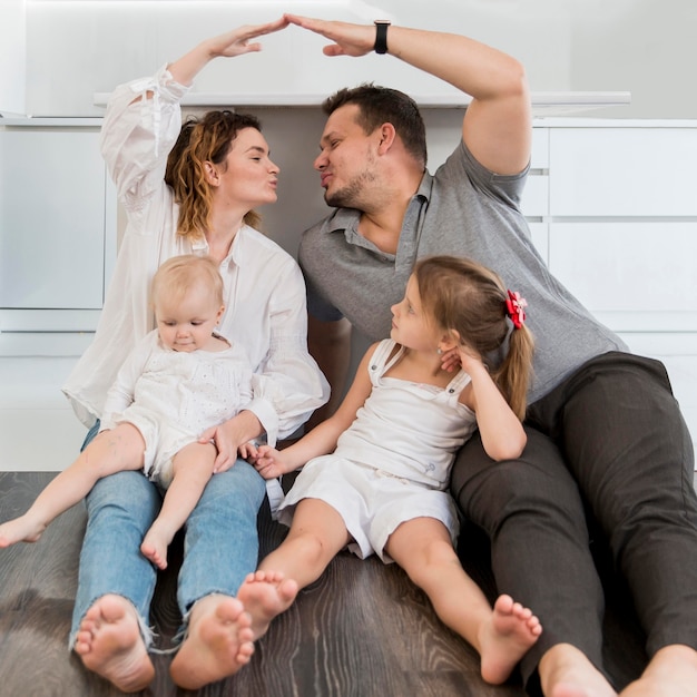 Full shot happy family on the floor