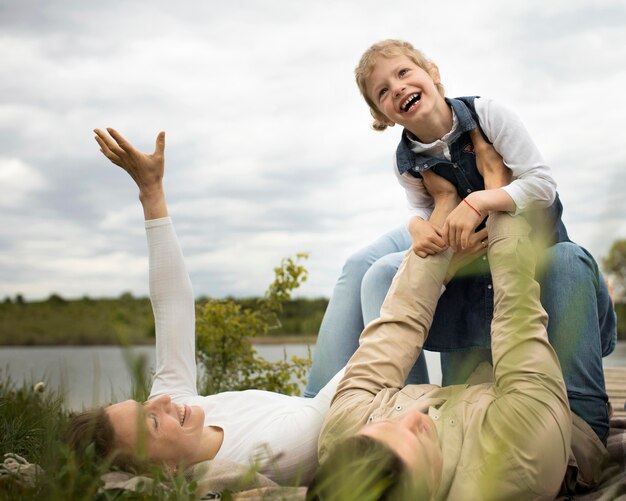 Full shot happy family in nature