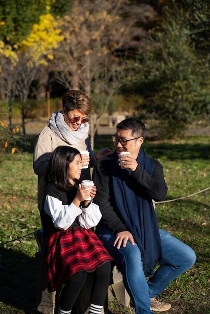 Full shot happy family in nature