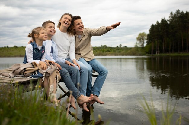 Full shot happy family outdoors