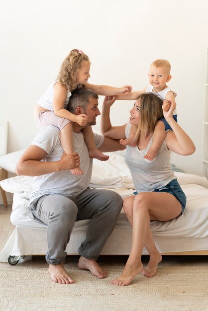 Full shot happy family playing together