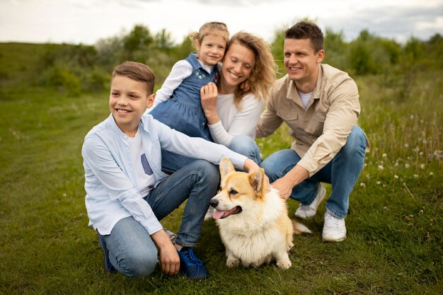 Full shot happy family with cute dog