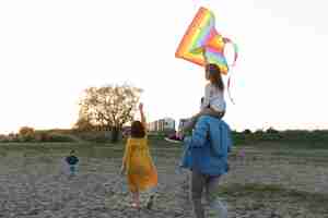 Free photo full shot happy family with kite