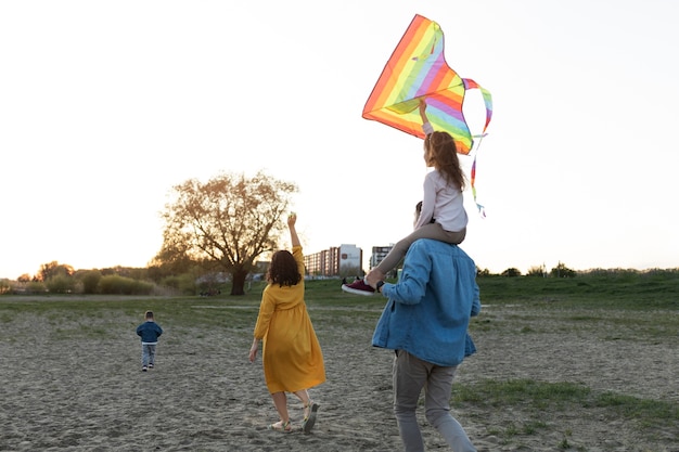 Full shot happy family with kite