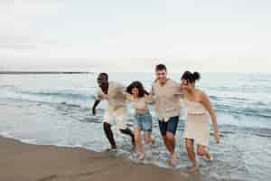 Free photo full shot happy friends at beach