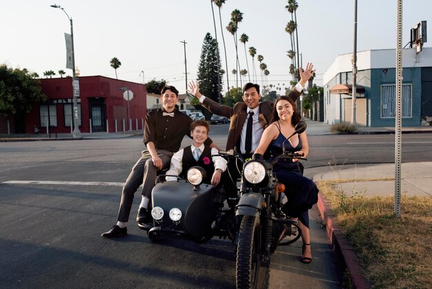 Full shot happy friends with motorcycle