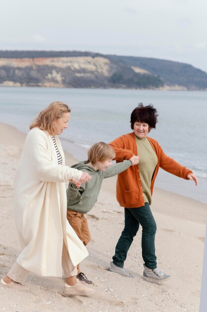 Full shot happy grandmothers and kid